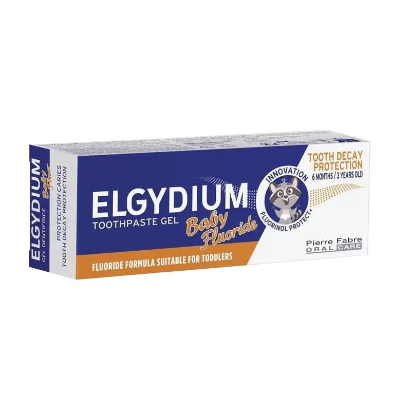 Boîte ELGYDIUM Baby Fluor dentifrice bleu avec accents orange, mascotte raton laveur, formule fluoré